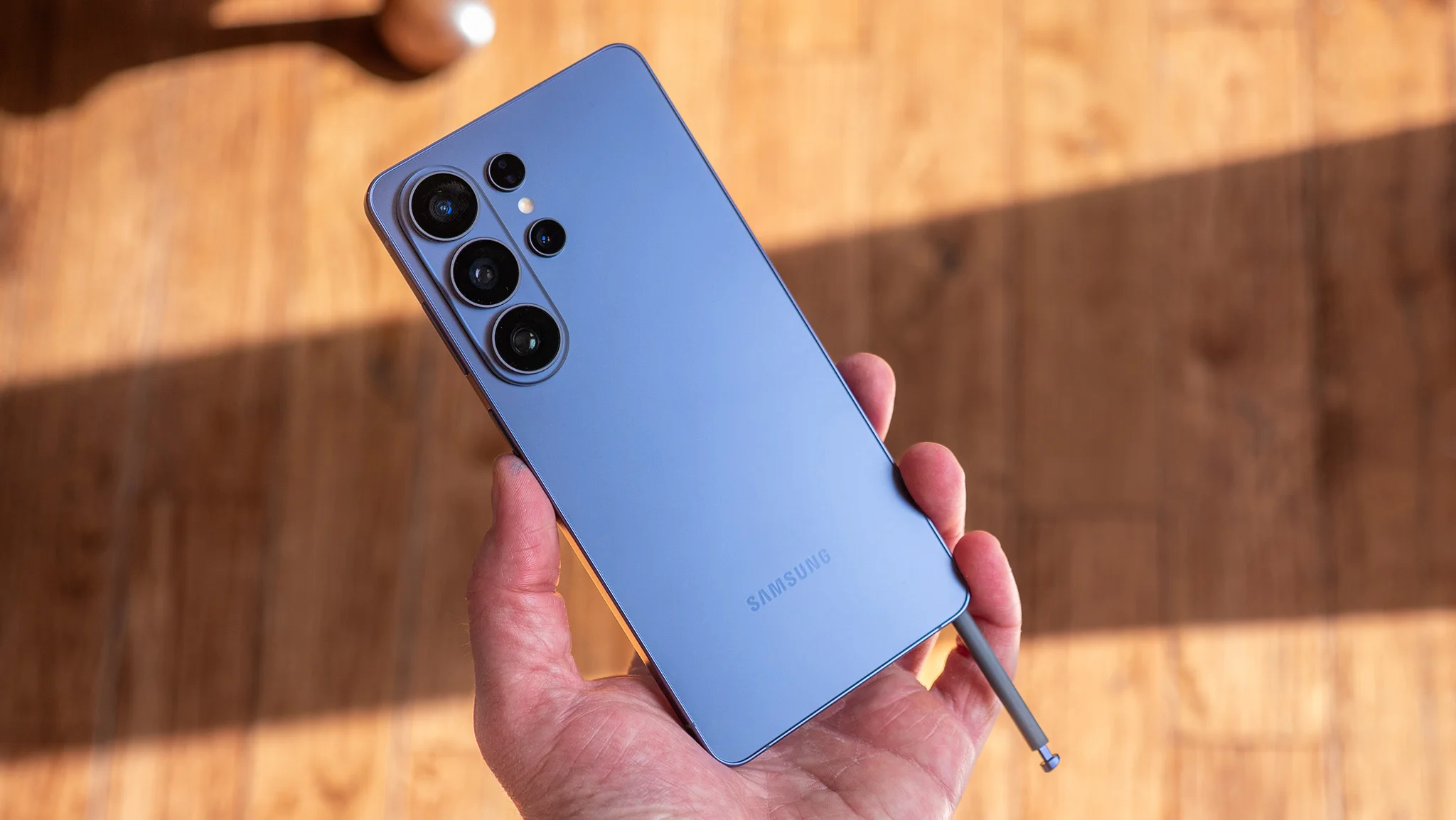 The blue Samsung Galaxy S26 Ultra with its S Pen sticking out of the sheath